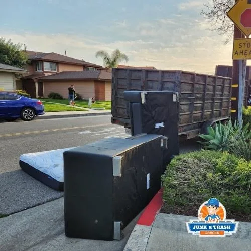 Junk removal in Irvine, CA, a large couch and furniture loaded by Joe's Junk and Trash Removal