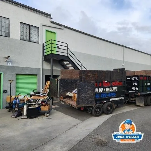 Joe's Junk and Trash Removal trailer loaded with junk outside a commercial property