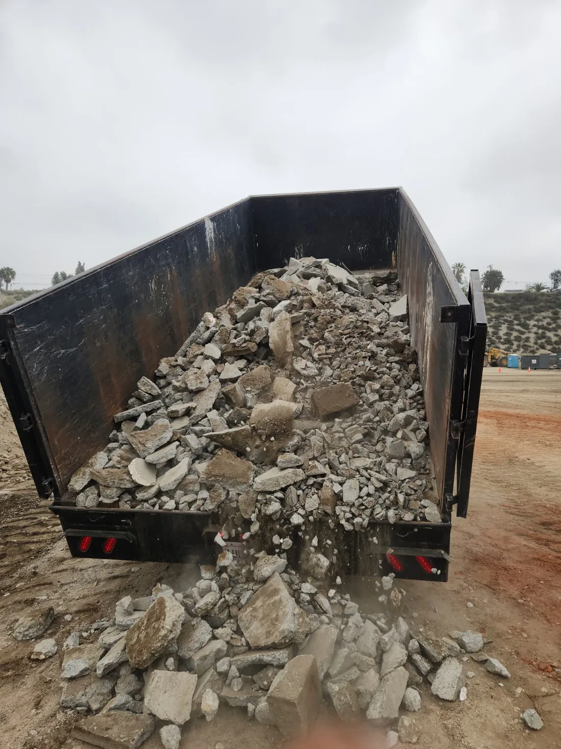 Concrete removal Orange, CA, a dump truck full of broken concrete hauled by Joe's Junk and Trash Removal