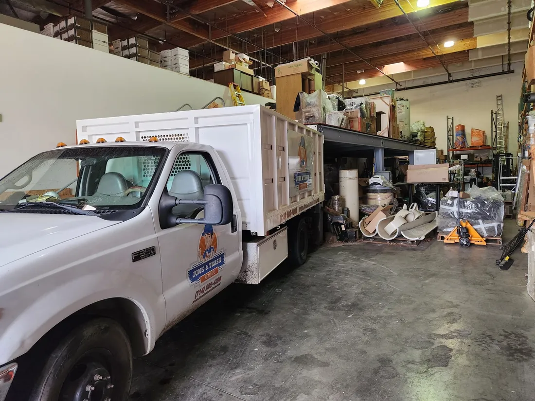 Garage cleanout in Orange, CA, Joe's Junk and Trash Removal truck loading a full garage